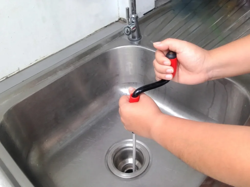 A close shot of hands snaking a sink for cleaning